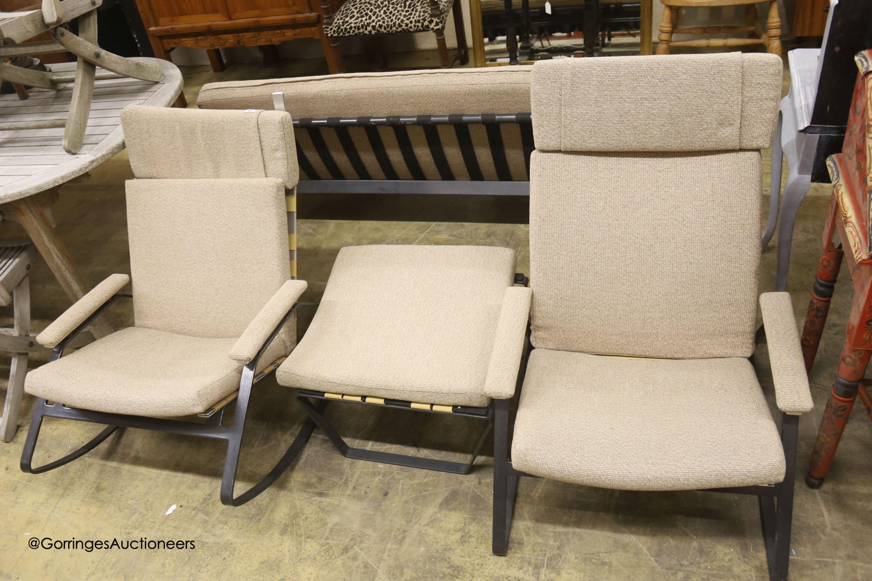 A mid century design wrought metal four piece lounge suite, comprising sofa, length 180cm, chair, rocking chair and a stool